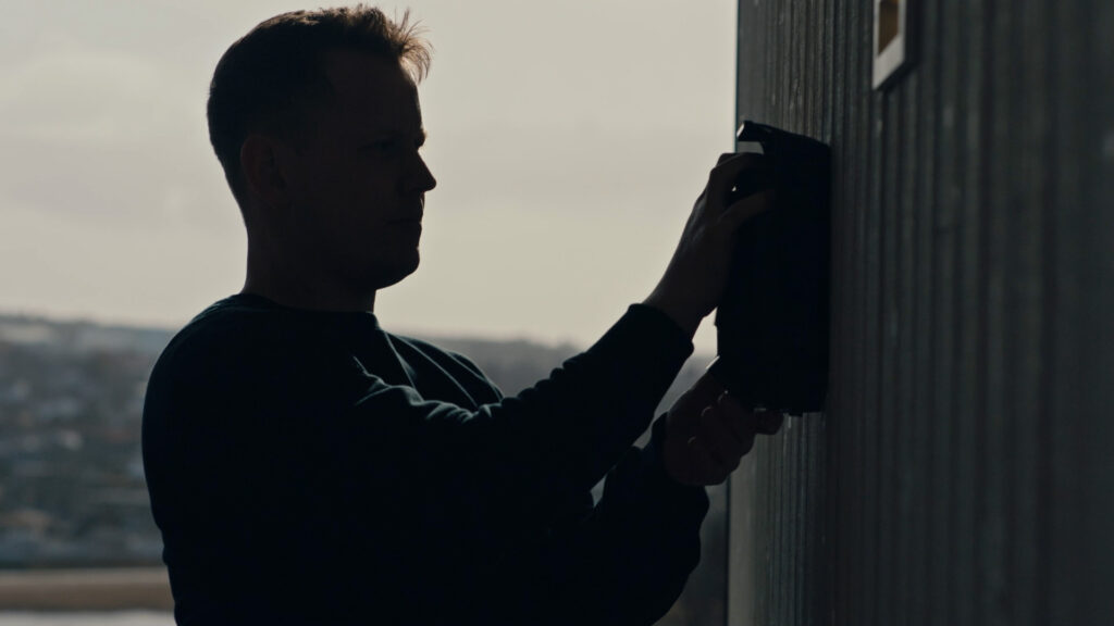 Electrician mounting an electric car charger