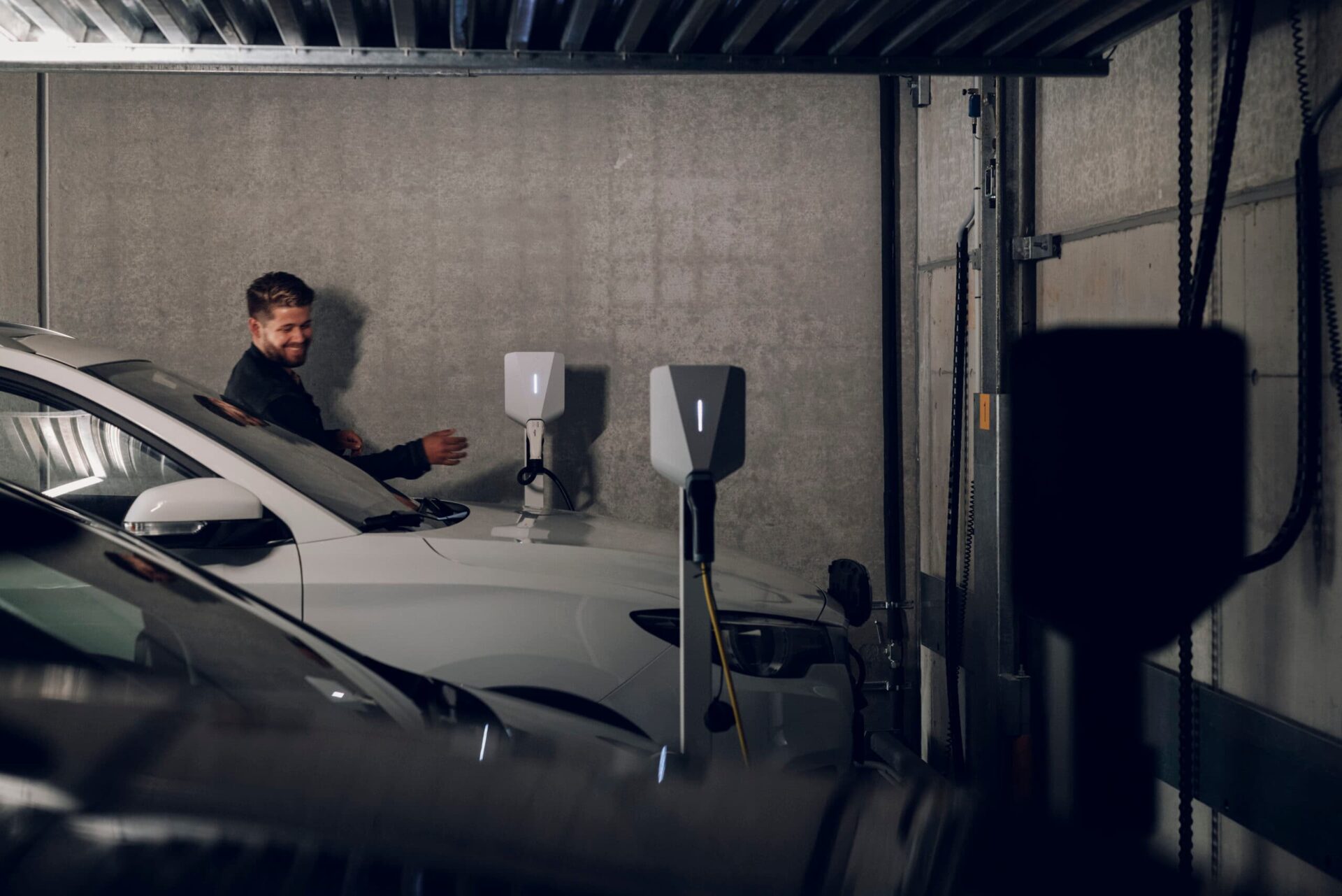 Man charging car in a garage