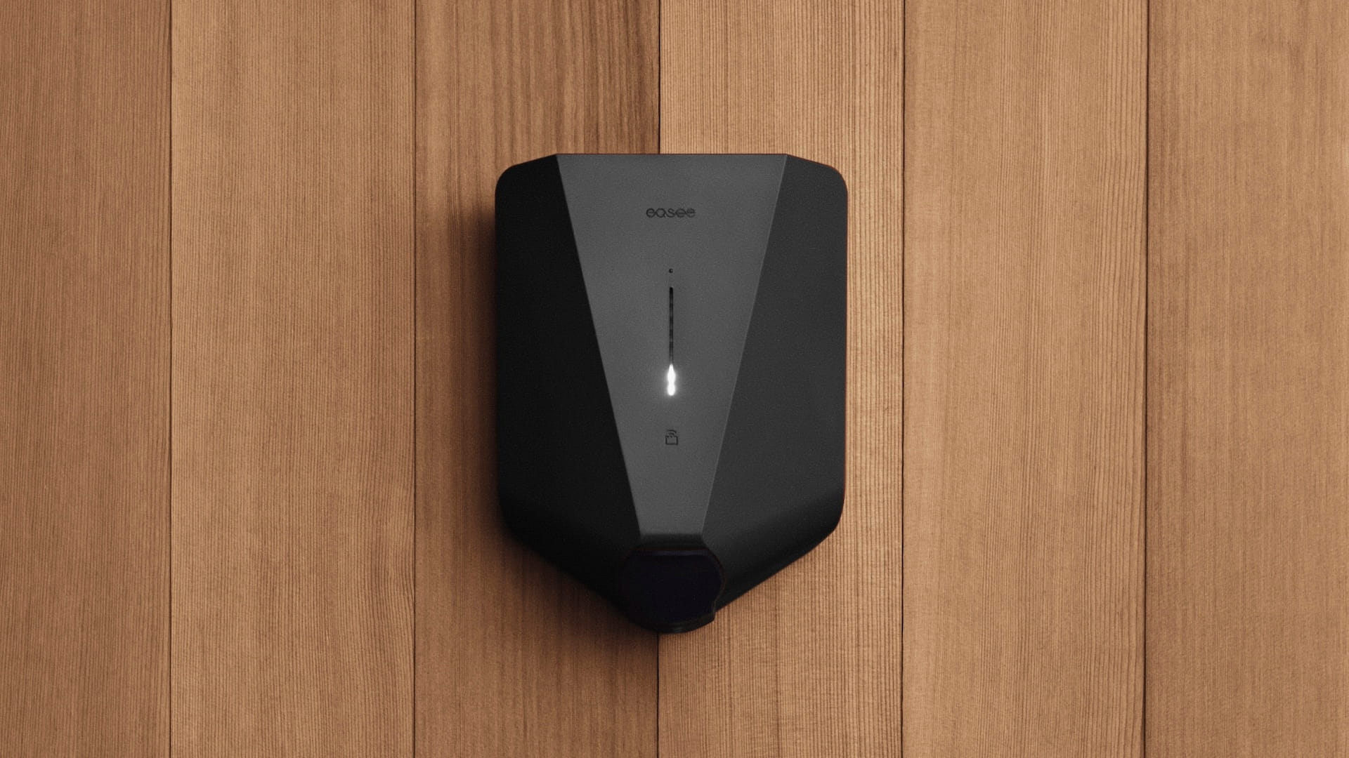 Black electric car charger on a wooden wall